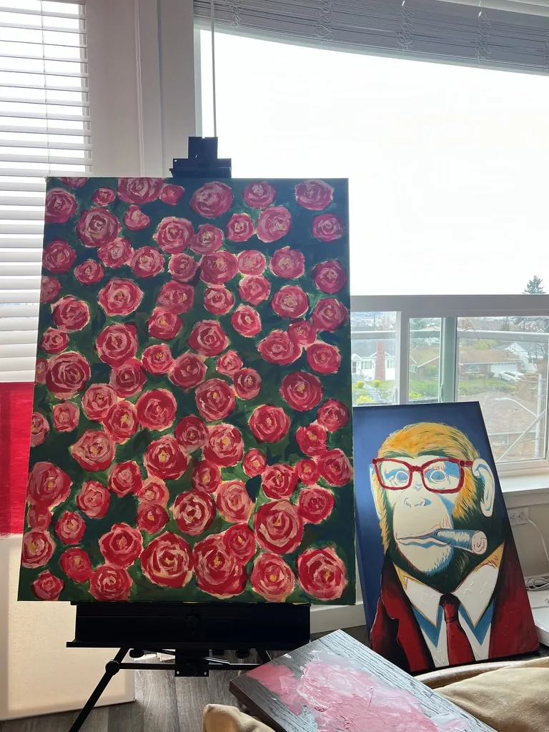 Acrylic canvas of red roses beside a pop art monkey in red glasses